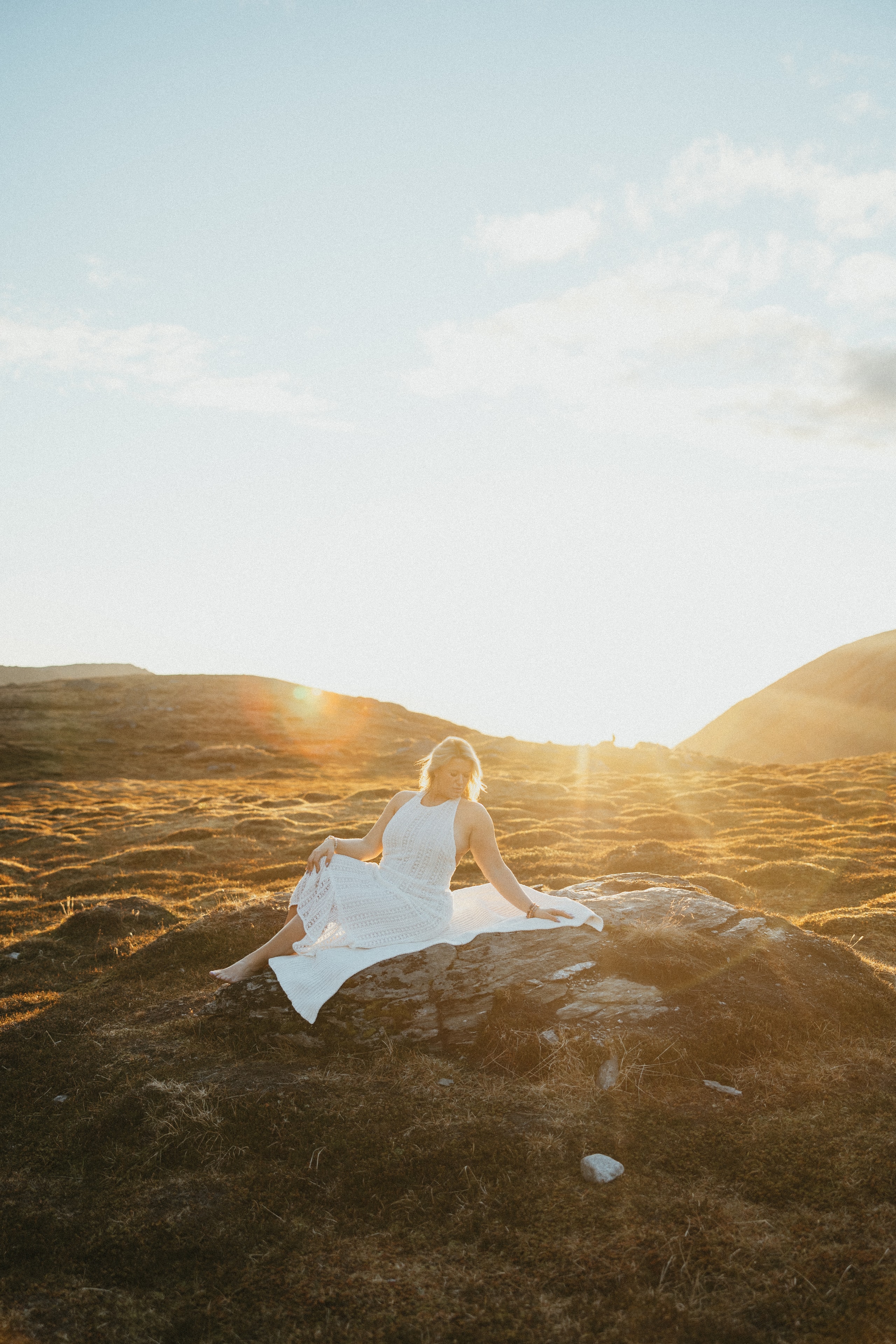 Brand photography by Lena Lee — woman in white dress on a desert rock